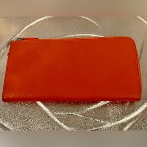 Bright orange leather zip around wallet. NWOT!